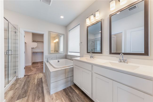 Primary bath with soaking tub double vanity. | Image 11