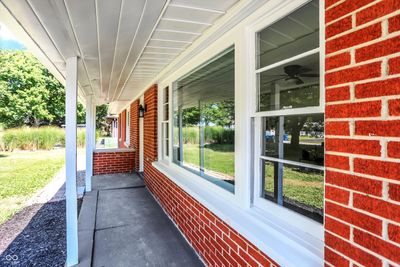 You'll love the covered front porch and attached two-car garage. | Image 1