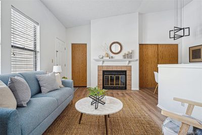 Wood fireplace and vaulted ceilings. | Image 2