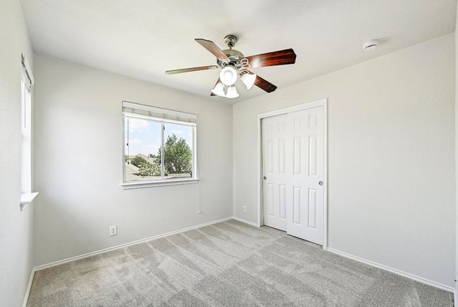 Unfurnished bedroom featuring carpet floors, a closet, and ceiling fan | Image 18
