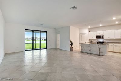 Unfurnished great room featuring light tile patterned flooring | Image 3