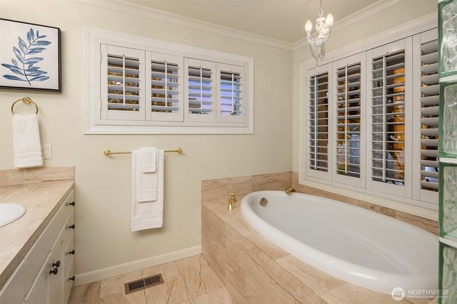 Settle into a soothing bath and say goodbye to the stresses of the day! Beautiful plantation shutters adorn the primary bath and the entire suite. | Image 19