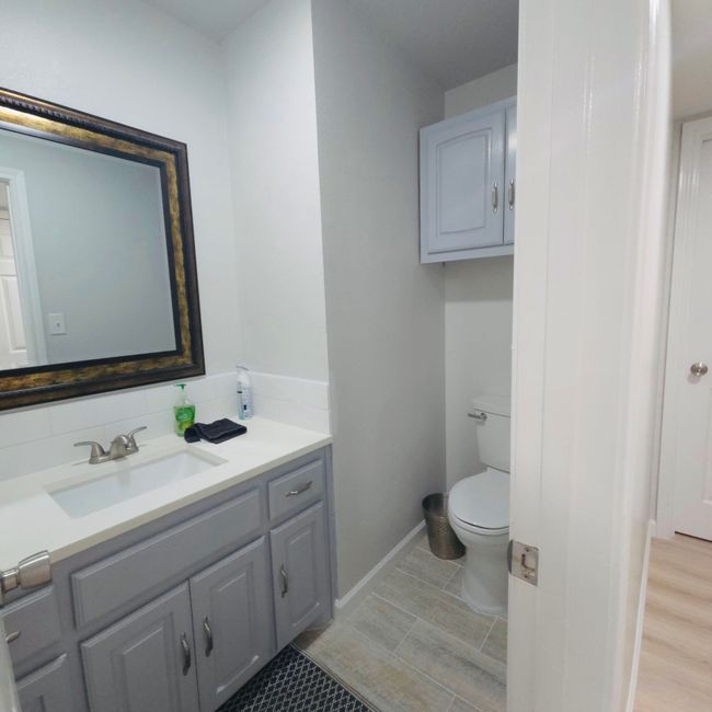 bath featuring vanity and tasteful backsplash | Image 20
