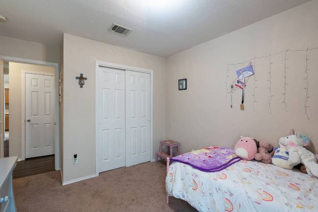 Carpeted bedroom with a closet and baseboards | Image 22