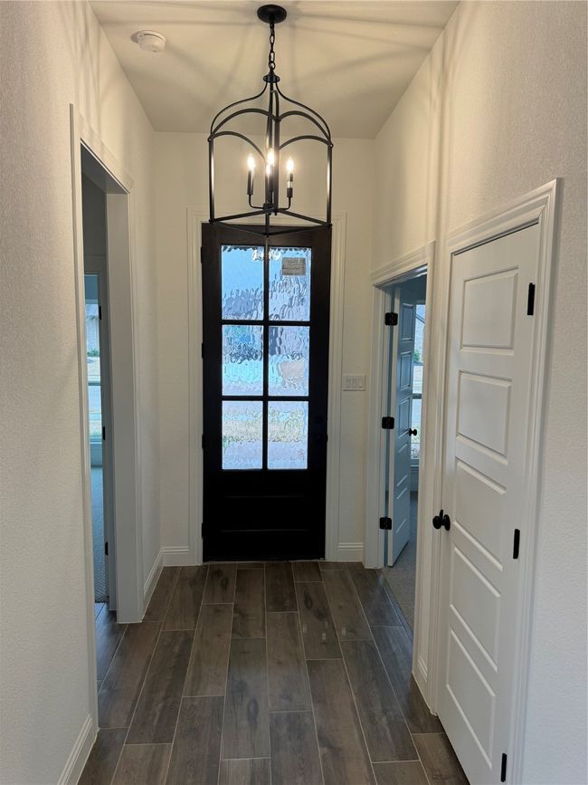 Doorway to outside featuring a notable chandelier | Image 10