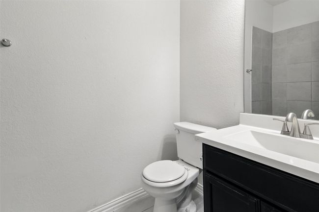 Bathroom with vanity and a textured wall | Image 15