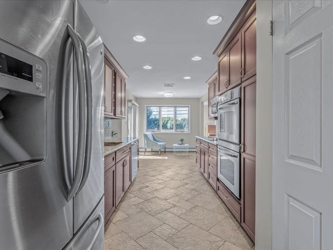 Kitchen featuring baseboards, stainless steel appliances, recessed lighting, and stone tile floors | Image 8