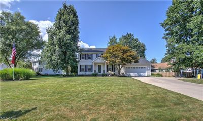 View of front of property featuring a garage and a front lawn | Image 1