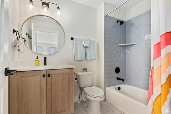 Full bath with shower / tub combo, toilet, vanity, and baseboards | Image 23