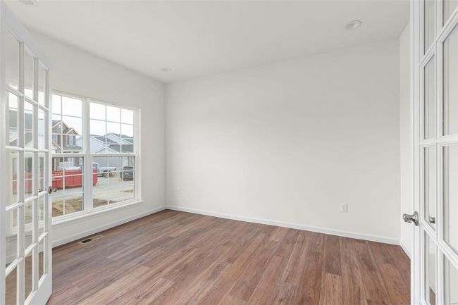 Empty room with hardwood / wood-style flooring and french doors | Image 29