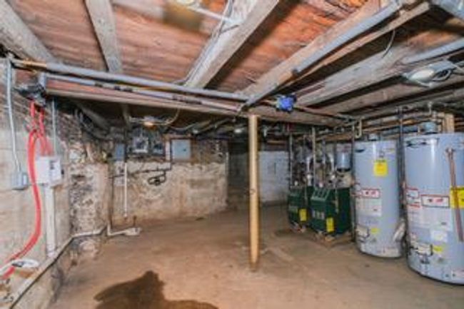 Unfinished basement featuring water heater | Image 23