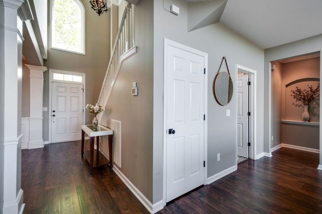 Notice the large arched picture frame window above the front door drenching the home in natural light and showcasing the stunning tree in the front yard. | Image 10