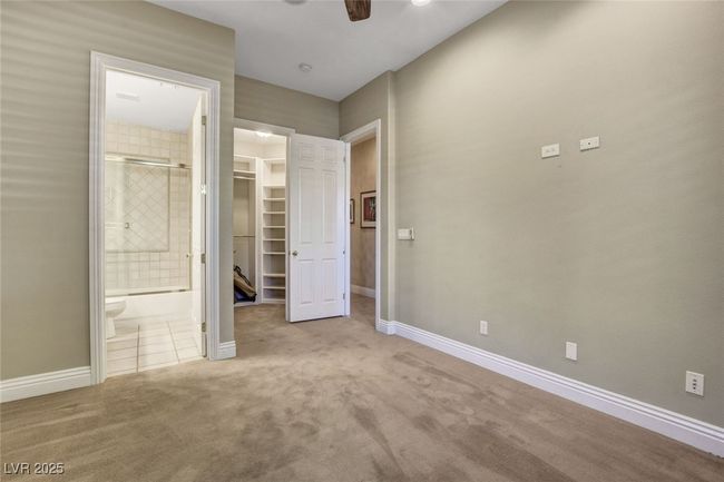 Unfurnished bedroom featuring ensuite bathroom, carpet floors, a closet, baseboards, and a spacious closet | Image 41