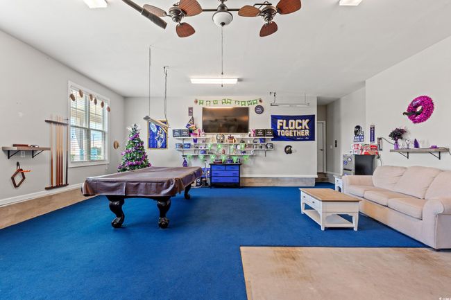 Recreation room with ceiling fan, carpet floors, and pool table | Image 37