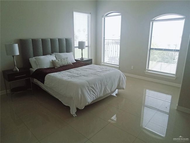 Bedroom with multiple windows and tile patterned flooring | Image 9