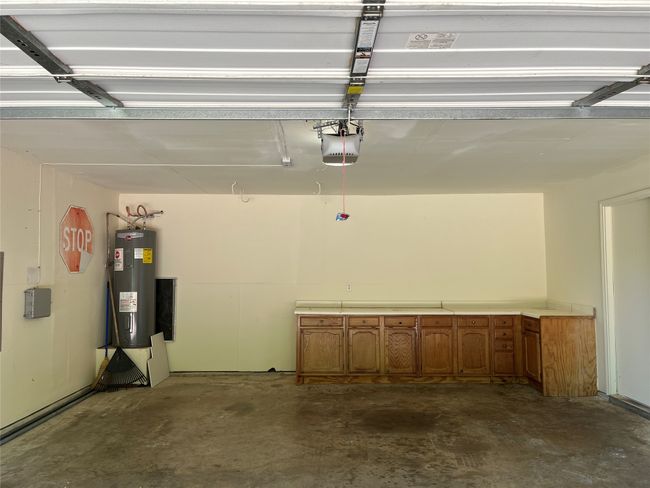 Garage with water heater and a garage door opener | Image 17