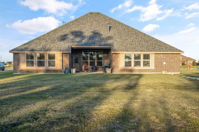 Back of property featuring roof with shingles, brick siding, and a lawn | Image 30