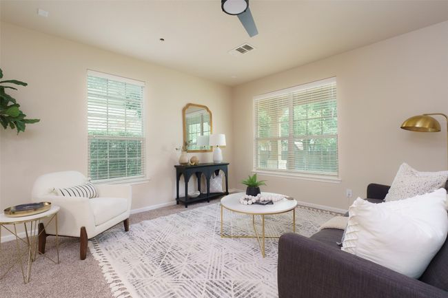 Living room with ceiling fan, baseboards, carpet flooring, and visible vents | Image 6