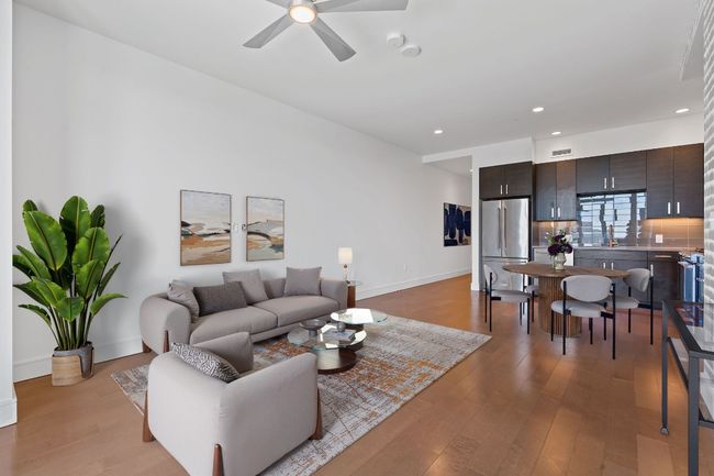 Living room with light wood finished floors, baseboards, visible vents, recessed lighting, and a ceiling fan | Image 7