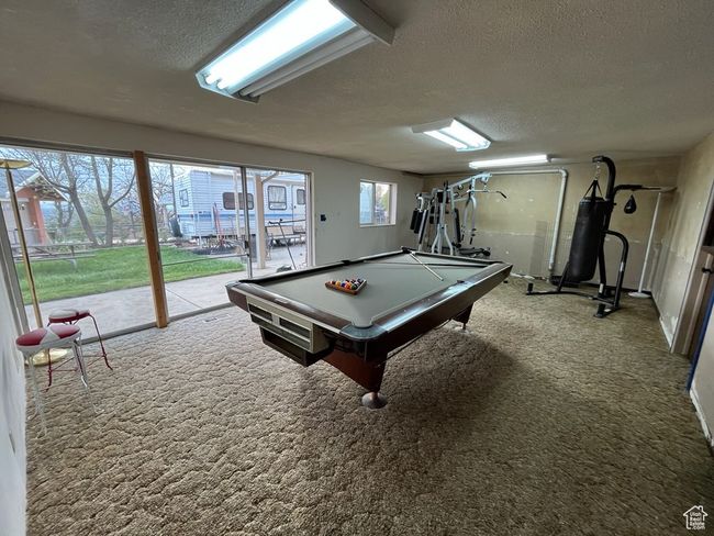 Rec room featuring a textured ceiling, carpet floors, and pool table | Image 24