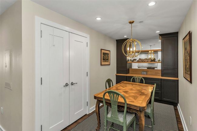 Dining room with baseboards, a chandelier, recessed lighting, and dark wood-type flooring | Image 4