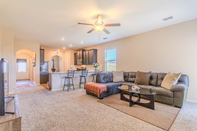 Carpeted living room featuring ceiling fan | Image 14