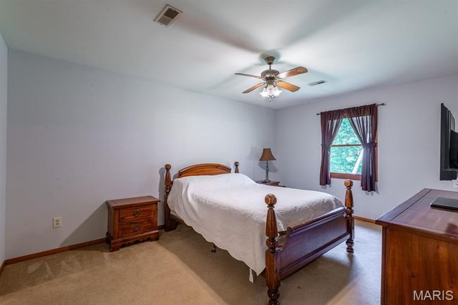 Carpeted bedroom with baseboards and ceiling fan | Image 12