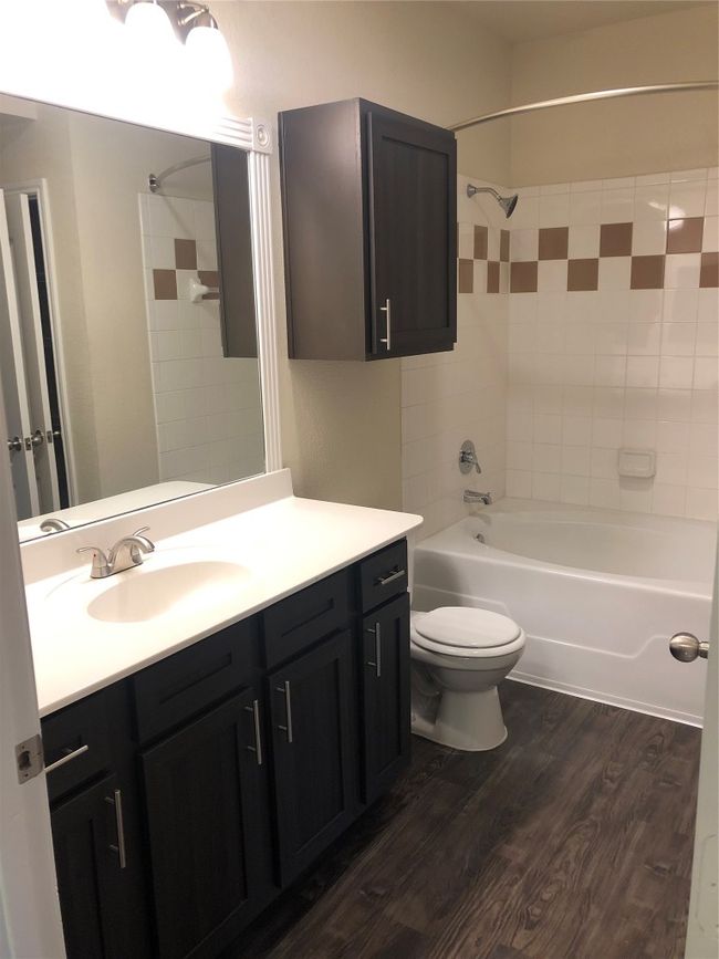 Bathroom with toilet, vanity, wood finished floors, and shower combination | Image 5