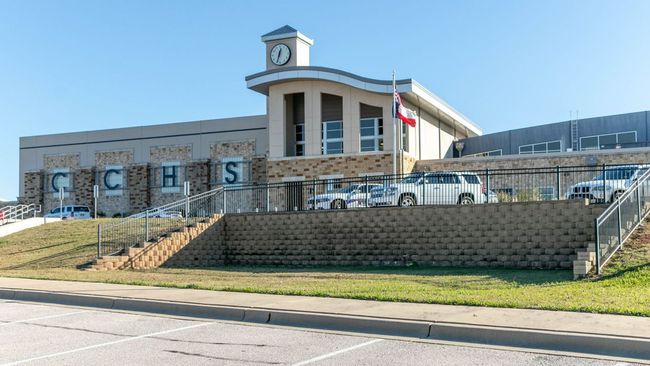 View of building exterior featuring stairway and uncovered parking | Image 20