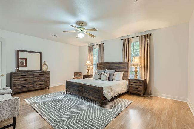 Bedroom with light wood-style flooring and a ceiling fan | Image 14