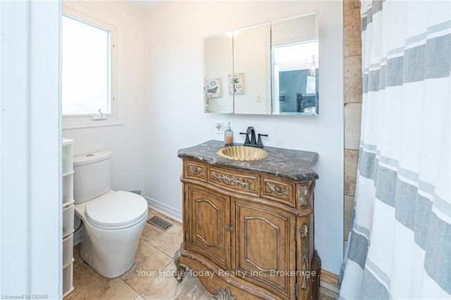 Bathroom with toilet, vanity, and tile patterned floors | Image 28