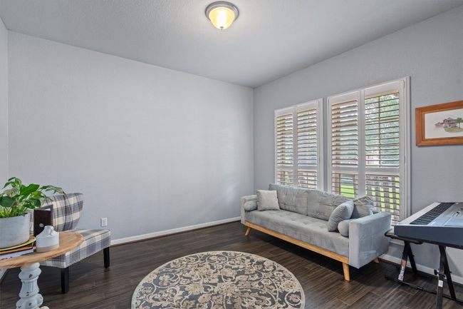 Sitting room with wood finished floors and baseboards | Image 6
