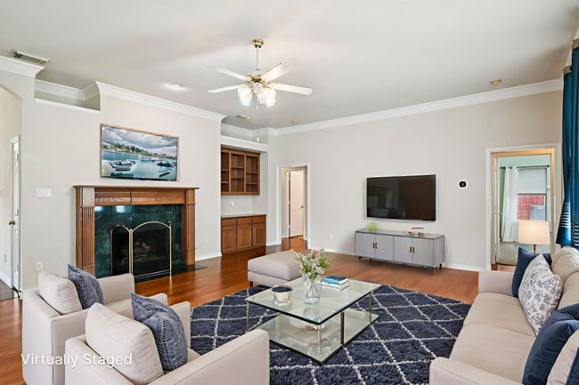 Virtually Staged Living room with ornamental molding, wood finished floors, a high end fireplace, and a ceiling fan | Image 5
