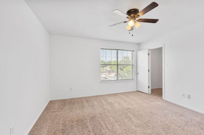 Carpeted spare room with a ceiling fan and baseboards | Image 33