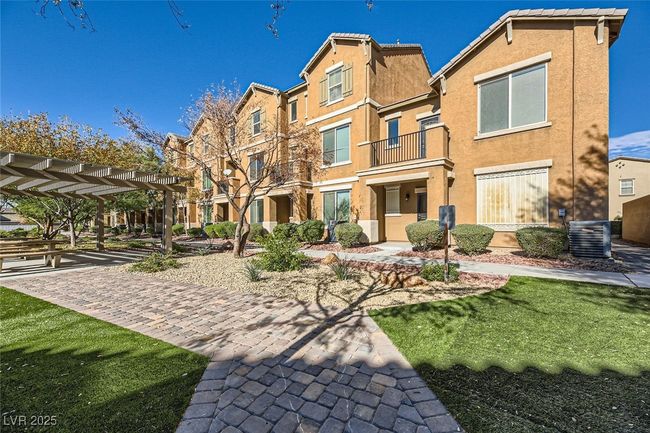 Back of house with stucco siding, a residential view, central AC unit, and a tiled roof | Image 4