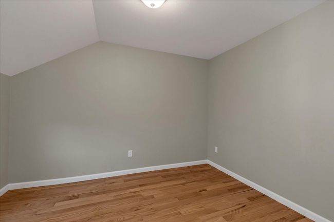Empty room with vaulted ceiling and light hardwood / wood-style flooring | Image 10