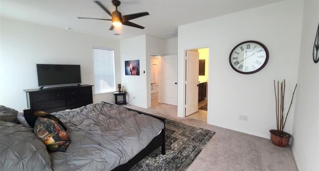 Bedroom with carpet flooring and a ceiling fan | Image 19