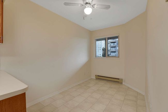 Spare room featuring baseboard heating, ceiling fan, and light tile patterned floors | Image 16