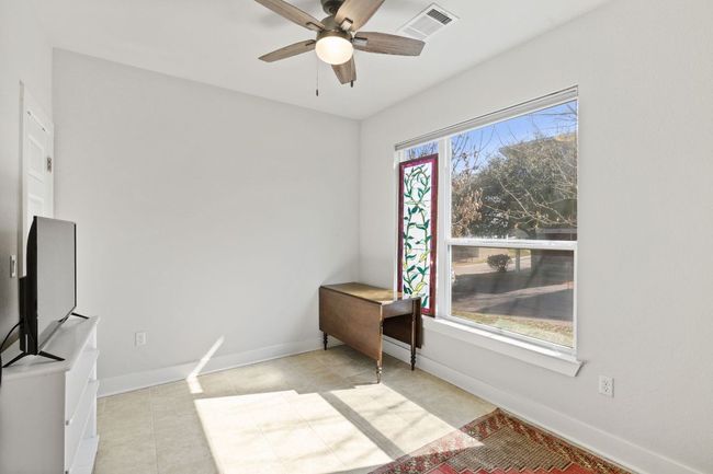 Unfurnished bedroom with baseboards, visible vents, ceiling fan, and tile patterned flooring | Image 13