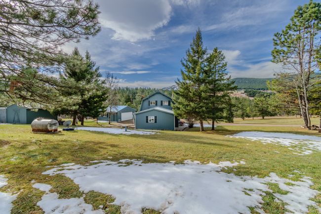 View of yard with a storage unit | Image 78