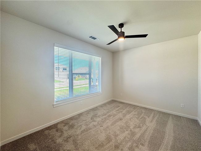 The secondary bedroom is a cozy and comfortable space, with ample room for a bed and additional furniture | Image 15