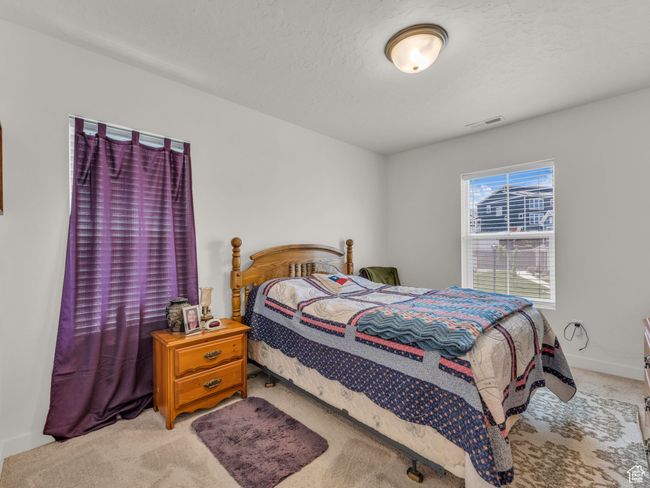 Bedroom featuring light carpet and baseboards | Image 17