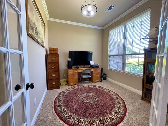 Office space with light colored carpet, crown molding, and baseboards | Image 8