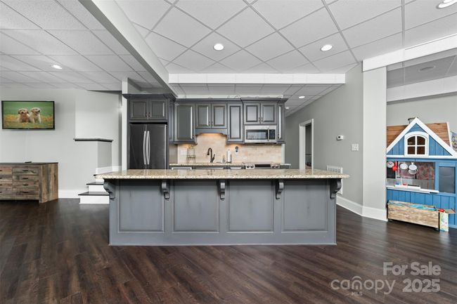 Basement Kitchen is flanked by two den areas. | Image 24