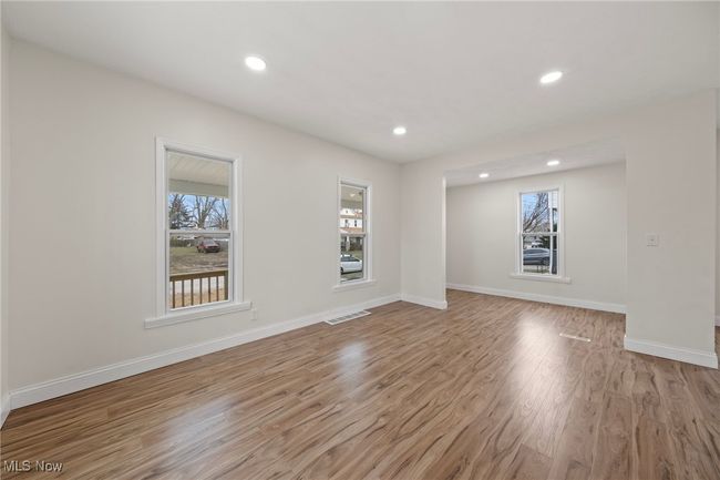 Spare room featuring light wood-type flooring | Image 9