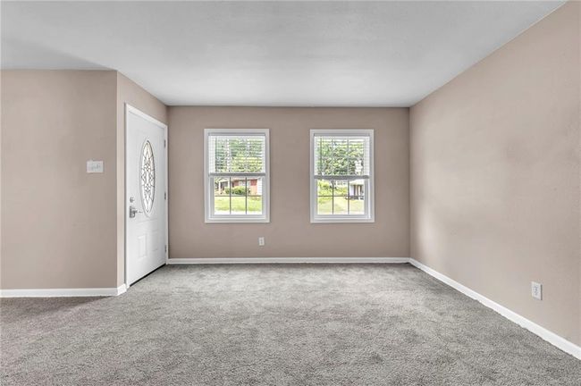 Carpeted entrance foyer with baseboards | Image 11