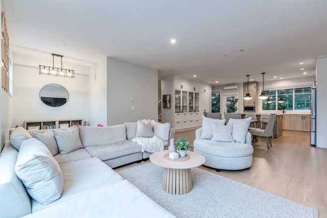 Living area with a wall mounted air conditioner, recessed lighting, and light wood-style flooring | Image 6