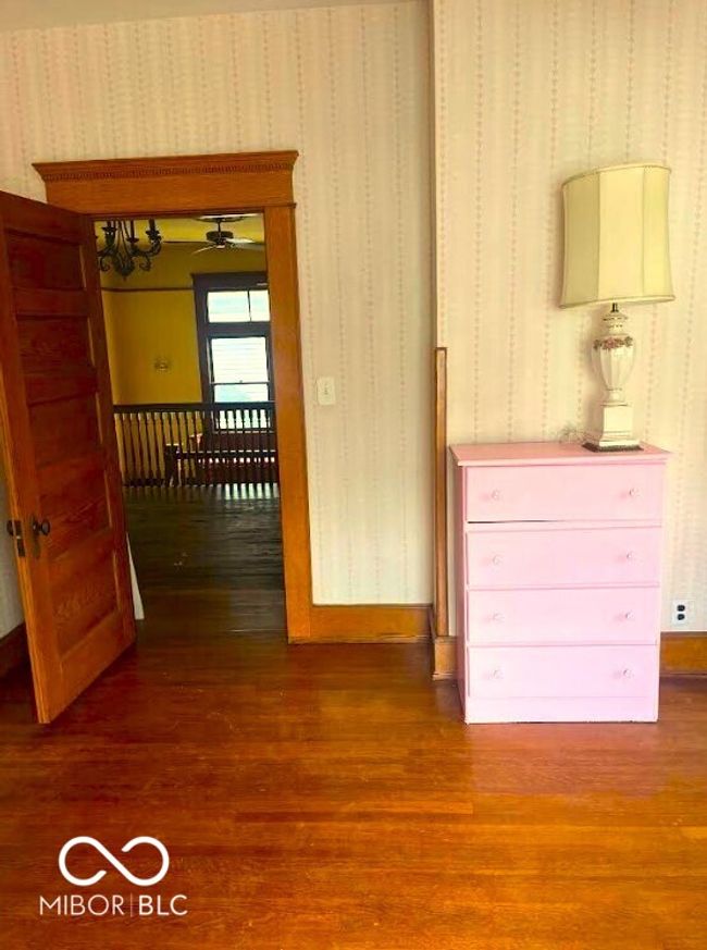 hallway featuring wood finished floors and wallpapered walls | Image 14