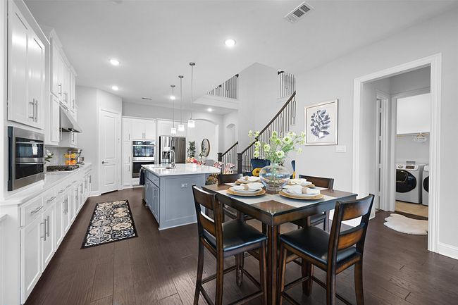 Breakfast Dining space flowing to the kitchen and access to the half bath and laundry room. | Image 12