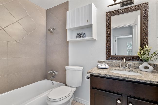 The primary bathroom boasts a beautiful granite vanity, offering both elegance and counter space for all your essentials. | Image 20
